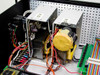 Interior close-up of Astec 12V and 5V power supplies and large yellow-wrapped transformer with wiring harness