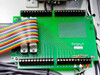 Interior close-up of relay I/O board PC 6222 Rev C (STA-U 9627/D 25249, copyright 1984) with rainbow ribbon cable attached