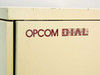 Opcom D.I.A.L. logo close-up on cabinet front panel – burgundy lettering on cream cabinet