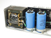 Power-One F24-12 – close-up of toroidal transformer with visible heat damage and Sprague Powerlytic capacitors