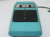 X-Rite 303 Sensitometer front view showing teal housing, black film platen, Power and Expose buttons on brushed-metal panel