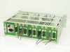 Wegener Communications 1601-54 Rev A Series 1600 mainframe rear three-quarter view showing green backplane PCB with card-edge connectors, IEC AC inlet, and ribbon cable leads