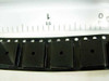 ON Semiconductor DF08S bridge rectifiers in tape strip rear view showing molded body and sprocket holes