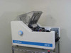 Infoseal 2612 tabletop folder sealer right-side view with top cover open showing internal mechanisms on wire shelf