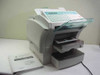 Minolta MinoltaFax 2800 Model 4154 laser fax machine front three-quarter view with document feeder raised, paper trays extended, and operator manual laid beside unit