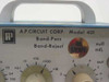A.P. Circuit Corp AP-401 front panel close-up — model 401 nameplate, Band-Pass Band-Reject designation, frequency multiplier knob (x0.1 to x1K), null adj. trimmer, and INV EXEMPT sticker