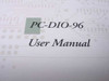 PC-DIO-96 User Manual interior page close-up showing model name and 'User Manual' title on circuit-board-patterned background