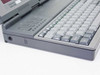 AST PowerExec 3/25SL left side — DC power jack, power switch, trackball cursor pad, and keyboard