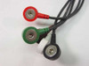 Close-up of four color-coded snap ECG electrode lead connectors — red, green, white, and black