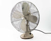 Robbins and Myers CG16 vintage electric desk fan — three-quarter front-left view showing wire cage guard, 3-blade metal fan, and black power cord