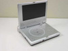 Initial IDM-1731 7-inch TFT portable DVD player open, front view showing disc tray and screen