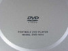 Initial DVD-1810 portable DVD player disc tray lid close-up showing DVD VIDEO logo and model number label