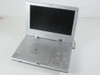 Initial DVD-1810 8-inch portable DVD player open with screen raised, front three-quarter view showing disc tray, speaker grilles, and control buttons