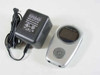 Rave-MP Arc2.5/5.0 MP3 player shown alongside its original AC adapter, front view