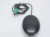 Microsoft X800128 Wireless Optical Mouse Receiver 3.0 – top view showing dark puck-style body with Microsoft logo and attached PS/2 cable