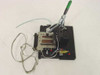 Custom PCB test jig fixture showing opposite angle — Carr Lane toggle clamp, brass pneumatic valve, red-capped fittings, and ribbon cables visible