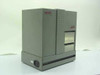 Esselte Meto Atlas AS40 industrial thermal label printer — front and left-side view showing steel enclosure and label exit slot