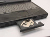 Compaq Armada 1700 laptop open — optical CD-ROM drive tray ejected showing drive mechanism