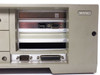 Wang PC240-3 right side panel open — showing four expansion slot bays, DB9 and DB25 rear I/O connectors, DIP switches, and vacant card slots