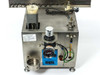 Micro Tooling MT0268 side panel view showing Festo pneumatic pressure regulator with gauge, Festo counter module, coiled air line, and stainless steel body