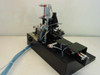 Applied Magnetics 559883 SFL Grammer head alignment machine — full right-side view showing linear slide base, pneumatic actuators, and tubing