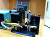 AMG Mono Gold Grammer air-actuated precision jig close-up with Nano probe head, pneumatic cylinder, and brass fittings — ID-P1890C label visible on base