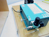 Rear view of AMG Mono Monolithic Gold Grammer electronic display unit showing pneumatic regulator, air fittings, and specification labels