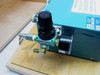 Close-up of pneumatic air regulator and brass fittings on rear of AMG Mono Gold Grammer display unit