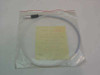 Trimedyne Model 317 fiber optic cable coiled in original bag, rear view showing full cable length and label