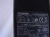 Toshiba PA3083U-1ACA rating label closeup showing INPUT 100-240V 1.2A-0.6A 50-60Hz, OUTPUT DC 15V 5A, UL CE GS certifications, manufactured October 2001 in China
