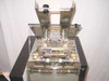 Omation 501 internal mechanism close-up with top cover open showing cutting and transport assembly