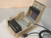 TEC B-427-DH20 thermal label printer with top cover open, revealing the printhead mechanism, platen, and media path with loading diagram label inside the lid
