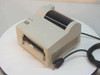 TEC B-427-DH20 thermal barcode label printer – front/right three-quarter view showing paper exit slot, vented side panel, and attached power cord