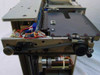Plasmon 555700-000 internal side view showing robotic disc transport mechanism, drive belt, stepper motor, and disc tray rail assembly