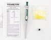 Hamilton 55019-05 SoftGrip pipette showing 25µL volume marking on barrel, alongside calibration certificate, yellow pipette tips in bag, and calibration adjustment tool