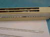 Close-up of psychrometer scale and thermometer slots showing internal rust damage from battery acid corrosion