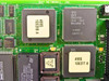 Bay Networks PCB close-up showing AMD MACH130-15JC CPLD, IC 4995 106399 A, 4995 106377 A, and ST Microelectronics chip with firmware label v4.00