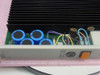 SynOptics LattisNet 3002 Power Supply interior close-up showing large electrolytic capacitors, PCB, multi-colored wiring harness, and finned heatsink