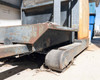 Clark OP15 forklift counterbalance and drive wheel base showing heavy surface rust, debris accumulation on outrigger arms, and worn drive tire