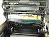 Tektronix Phaser IIsd 4684 internal mechanism close-up – thermal transfer roller assembly with HOT Surface warning label