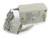 Apple M8010 StyleWriter Power Adapter — three-quarter front view showing beige housing, AC prongs, DC barrel output cable, and paper label wrap