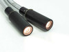 Dual output tips illuminated, showing bright copper-colored fiber bundle faces lit from within both 19mm cylindrical output housings