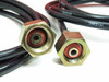 Close-up of two Hydac high-pressure hose end fittings showing swivel brass hex connectors with red seals and HYDAC-branded hose