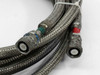 Close-up of CTI 8043074 helium compressor line couplings showing green-coded and red-coded Aeroquip 5400-S5-8 refrigerant quick-disconnect fittings on braided hoses