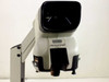 Vision Engineering Mantis stereo microscope — front view with Vision Engineering and MANTIS PATENTED badge visible; objective carousel shown below head