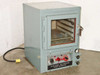 Hotpack Model 733 Electric Vacuum Oven front view — grey-blue cabinet with glass window door, control panel, and yellow power cord
