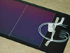 Uni-Solar PVL-128T flexible solar panel laid flat showing purple-blue amorphous cell surface, clear cell segments, output cable, and MC3 connector with product label