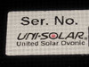 Uni-Solar brand label close-up reading UNI-SOLAR United Solar Ovonic with serial number field