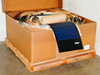 Uni-Solar PVL-136 flexible solar panel carton of 30 on pallet, box open showing panels coiled with brown paper interleaving