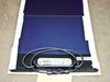 Uni-Solar ePVL-144T PowerBond solar panel laid flat showing amorphous cell surface, junction box, and MC4 connector cables coiled on top